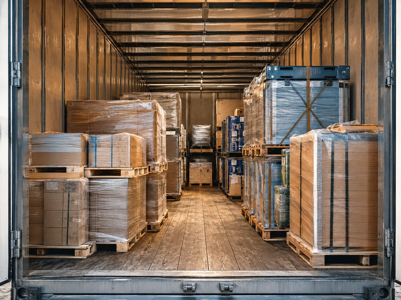 Pallets of freight organized and secured inside a shipping trailer