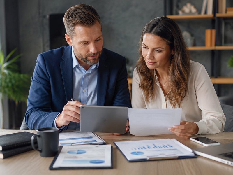 An advisor reviewing account growth charts with clients, representing indexed universal life's flexible protection and cash-value growth potential